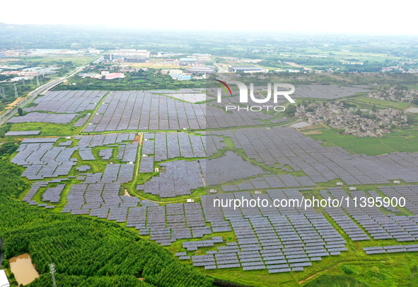 A photovoltaic power station is being shown in Ligang village, Chaohu city, East China's Anhui province, on July 9, 2024. 