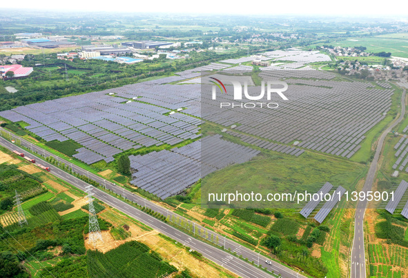 A photovoltaic power station is being shown in Ligang village, Chaohu city, East China's Anhui province, on July 9, 2024. 