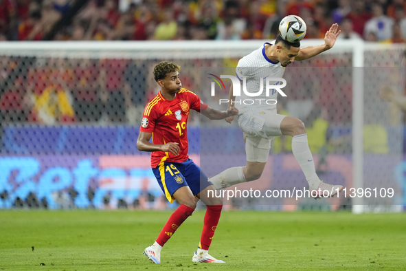 William Saliba centre-back of France and Arsenal FC and Lamine Yamal right winger of Spain and FC Barcelona compete for the ball during the...