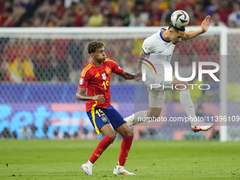 William Saliba centre-back of France and Arsenal FC and Lamine Yamal right winger of Spain and FC Barcelona compete for the ball during the...