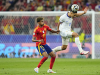 William Saliba centre-back of France and Arsenal FC and Lamine Yamal right winger of Spain and FC Barcelona compete for the ball during the...