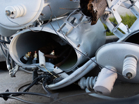 A fallen power line's distribution transformer is becoming misshapen and broken from the powerful winds of Hurricane Beryl in Houston, Texas...