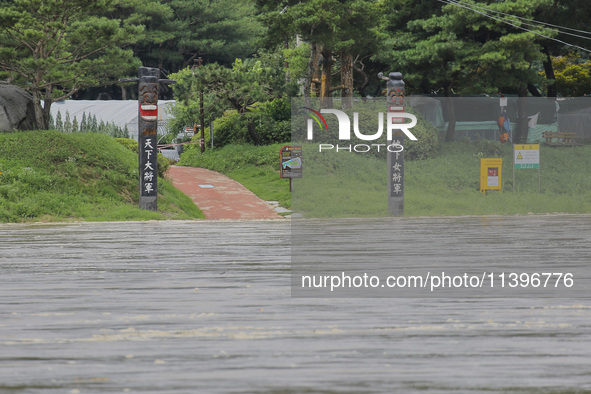 The road connecting the village is being cut off due to the flood caused by the heavy rain last night at Hoeryongpo village in Yecheon, Sout...