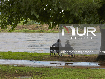 People are watching the river that is overflowing to the danger level due to the heavy rain last night at Younggang-river in Moongyeong, Sou...