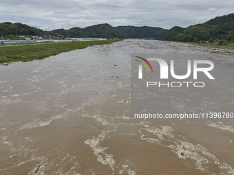 A general view of the river that is overflowing to the danger level due to the heavy rain last night at Younggang-river in Moongyeong, South...