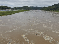 A general view of the river that is overflowing to the danger level due to the heavy rain last night at Younggang-river in Moongyeong, South...