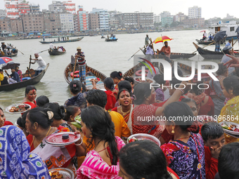 Hindu devotees are gathering beside the river Buriganga to float their lamps just after Bipodnashini Puja in Dhaka, Bangladesh, on July 09,...