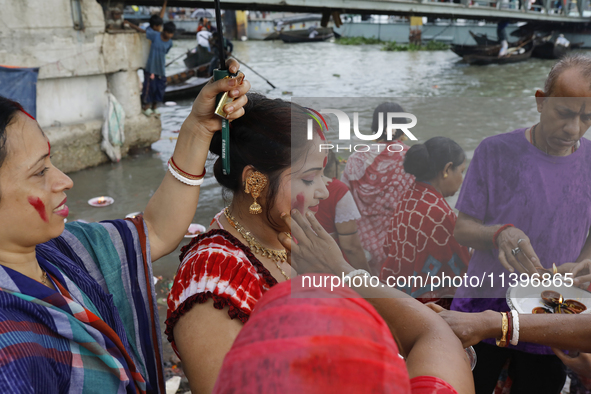 Hindu devotees are gathering beside the river Buriganga to float their lamps just after Bipodnashini Puja in Dhaka, Bangladesh, on July 09,...