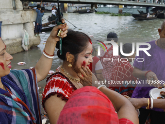 Hindu devotees are gathering beside the river Buriganga to float their lamps just after Bipodnashini Puja in Dhaka, Bangladesh, on July 09,...