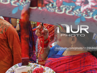 Hindu devotees are gathering beside the river Buriganga to float their lamps just after Bipodnashini Puja in Dhaka, Bangladesh, on July 09,...