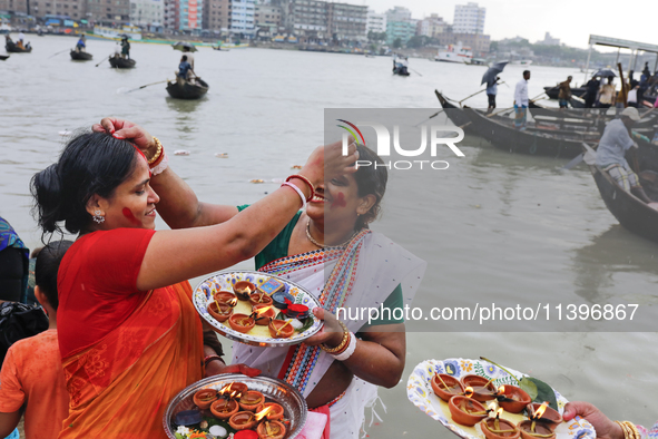 Hindu devotees are gathering beside the river Buriganga to float their lamps just after Bipodnashini Puja in Dhaka, Bangladesh, on July 09,...