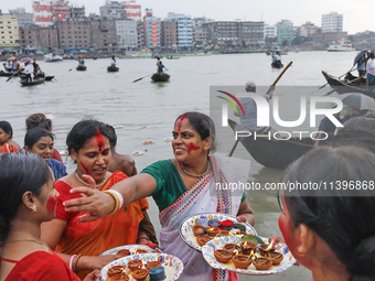 Hindu devotees are gathering beside the river Buriganga to float their lamps just after Bipodnashini Puja in Dhaka, Bangladesh, on July 09,...