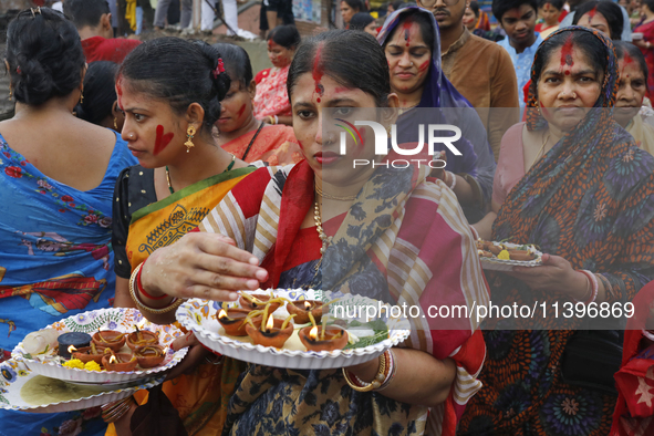 Hindu devotees are gathering beside the river Buriganga to float their lamps just after Bipodnashini Puja in Dhaka, Bangladesh, on July 09,...