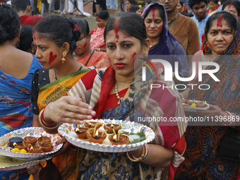 Hindu devotees are gathering beside the river Buriganga to float their lamps just after Bipodnashini Puja in Dhaka, Bangladesh, on July 09,...