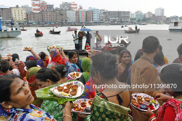 Hindu devotees are gathering beside the river Buriganga to float their lamps just after Bipodnashini Puja in Dhaka, Bangladesh, on July 09,...