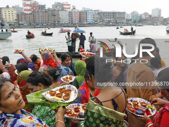 Hindu devotees are gathering beside the river Buriganga to float their lamps just after Bipodnashini Puja in Dhaka, Bangladesh, on July 09,...