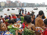 Hindu devotees are gathering beside the river Buriganga to float their lamps just after Bipodnashini Puja in Dhaka, Bangladesh, on July 09,...