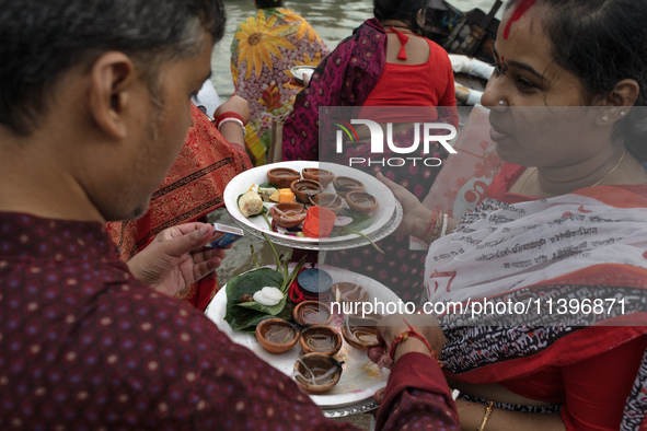 Hindu devotees are gathering beside the river Buriganga to float their lamps just after Bipodnashini Puja in Dhaka, Bangladesh, on July 09,...