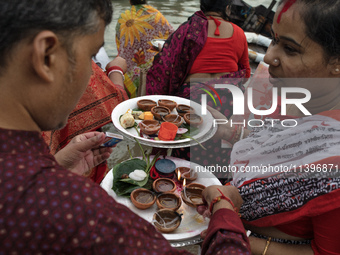 Hindu devotees are gathering beside the river Buriganga to float their lamps just after Bipodnashini Puja in Dhaka, Bangladesh, on July 09,...