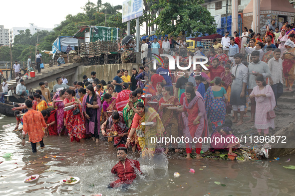 Hindu devotees are gathering beside the river Buriganga to float their lamps just after Bipodnashini Puja in Dhaka, Bangladesh, on July 09,...