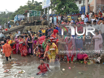 Hindu devotees are gathering beside the river Buriganga to float their lamps just after Bipodnashini Puja in Dhaka, Bangladesh, on July 09,...