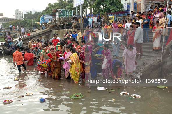 Hindu devotees are gathering beside the river Buriganga to float their lamps just after Bipodnashini Puja in Dhaka, Bangladesh, on July 09,...