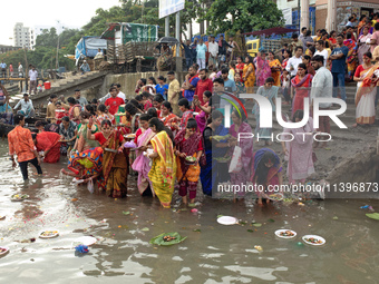 Hindu devotees are gathering beside the river Buriganga to float their lamps just after Bipodnashini Puja in Dhaka, Bangladesh, on July 09,...