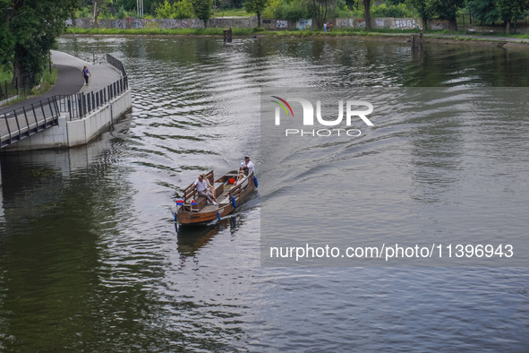 A boat is going on the Brda River in Bydgoszcz, Poland, on May 30, 2024 