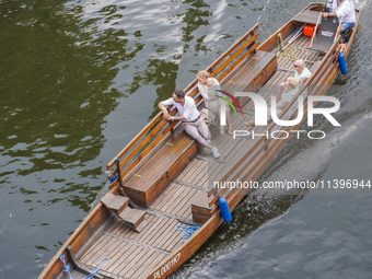 Two pairs of tourists are going on a travel boat by the Brda River in Bydgoszcz, Poland, on May 30, 2024 (