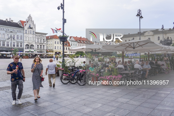 A general view of the old town street with open-air restaurants is being seen in Bydgoszcz, Poland, on May 30, 2024. 