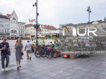 A general view of the old town street with open-air restaurants is being seen in Bydgoszcz, Poland, on May 30, 2024. (