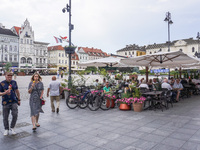 A general view of the old town street with open-air restaurants is being seen in Bydgoszcz, Poland, on May 30, 2024. (