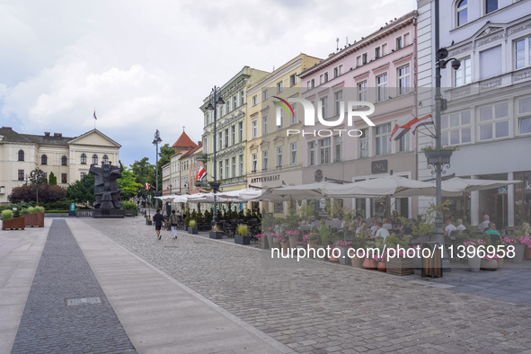 A general view of the old town street with open-air restaurants is being seen in Bydgoszcz, Poland, on May 30, 2024. 