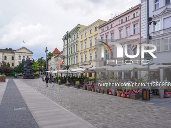 A general view of the old town street with open-air restaurants is being seen in Bydgoszcz, Poland, on May 30, 2024. (