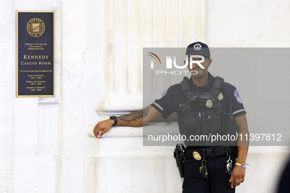 A U.S. Capitol Police officer stands guard outside of a meeting between a bipartisan group of U.S. Senators and leaders from NATO on Capitol...