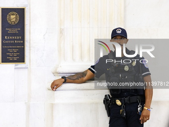 A U.S. Capitol Police officer stands guard outside of a meeting between a bipartisan group of U.S. Senators and leaders from NATO on Capitol...