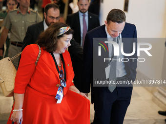 Karen Pierce, British Ambassador to the United States, left in red, departs a meeting between a bipartisan group of U.S. Senators and leader...