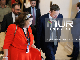 Karen Pierce, British Ambassador to the United States, left in red, departs a meeting between a bipartisan group of U.S. Senators and leader...