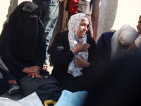 Palestinians are mourning over the bodies of loved ones following Israeli bombardment in Deir el-Balah in the central Gaza Strip on July 10,...