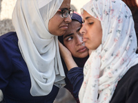 Palestinians are mourning over the bodies of loved ones following Israeli bombardment in Deir el-Balah in the central Gaza Strip on July 10,...