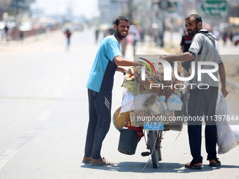 Displaced Palestinians are fleeing from Gaza City and are walking along Salah al-Din Street as they are arriving at the Nuseirat refugee cam...