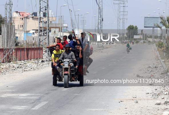 Displaced Palestinians are fleeing from Gaza City and are walking along Salah al-Din Street as they are arriving at the Nuseirat refugee cam...