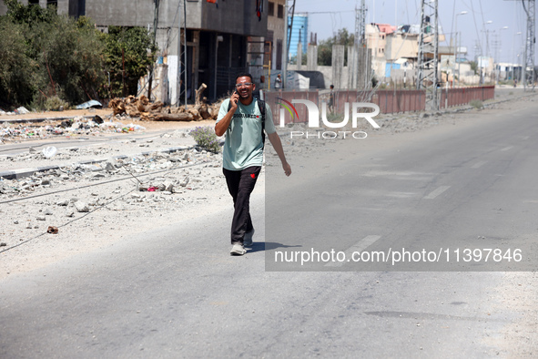 Displaced Palestinians are fleeing from Gaza City and are walking along Salah al-Din Street as they are arriving at the Nuseirat refugee cam...