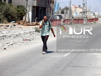 Displaced Palestinians are fleeing from Gaza City and are walking along Salah al-Din Street as they are arriving at the Nuseirat refugee cam...