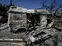 A journalist is standing in front of a van damaged by the July 8 Russian missile attack in Vilniansk, Zaporizhzhia region, southeastern Ukra...