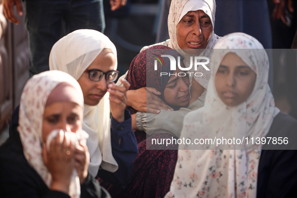 Palestinians are mourning over the bodies of loved ones following Israeli bombardment in Deir el-Balah in the central Gaza Strip on July 10,...