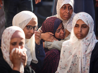 Palestinians are mourning over the bodies of loved ones following Israeli bombardment in Deir el-Balah in the central Gaza Strip on July 10,...