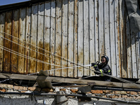 A firefighter is putting out a fire in a building damaged by the July 8 Russian missile attack in Vilniansk, Zaporizhzhia region, southeaste...