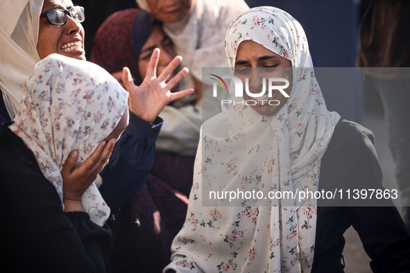 Palestinians are mourning over the bodies of loved ones following Israeli bombardment in Deir el-Balah in the central Gaza Strip on July 10,...