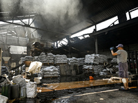 A man is standing in a hangar with agricultural products damaged by the July 8 Russian missile attack in Vilniansk, Ukraine, on July 9, 2024...